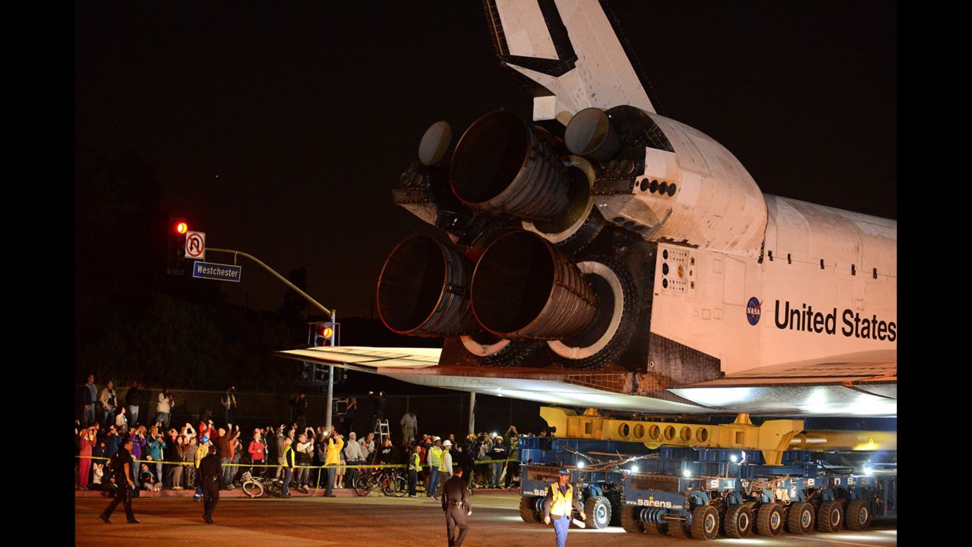 Bystanders watch as Endeavour moves out of the Los Angeles airport and onto a public street.