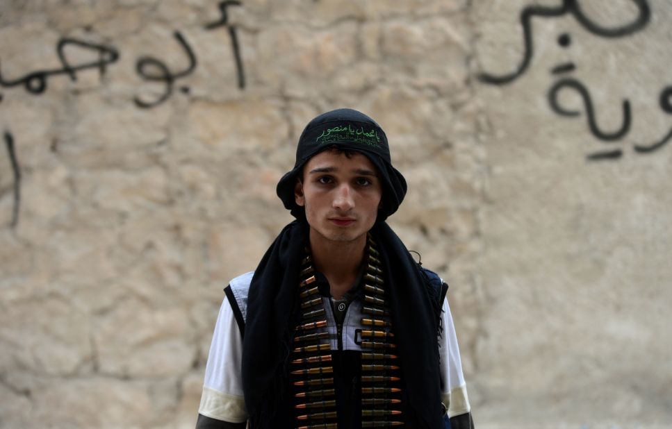 A Syrian opposition fighter stands near a post in Aleppo on October 11, 2012.