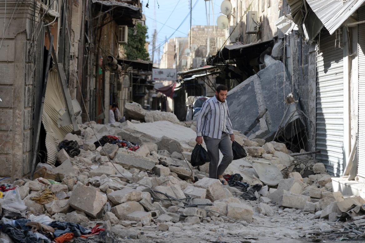 A Syrian man walks through rubble in Aleppo on Thursday.