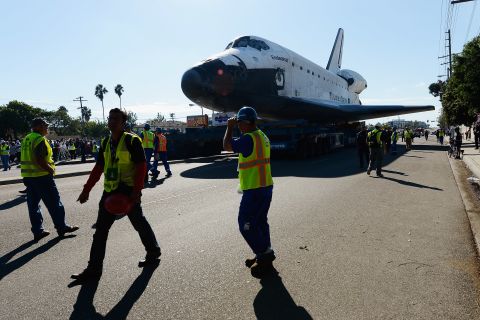 Workers escort Endeavour on its journey.