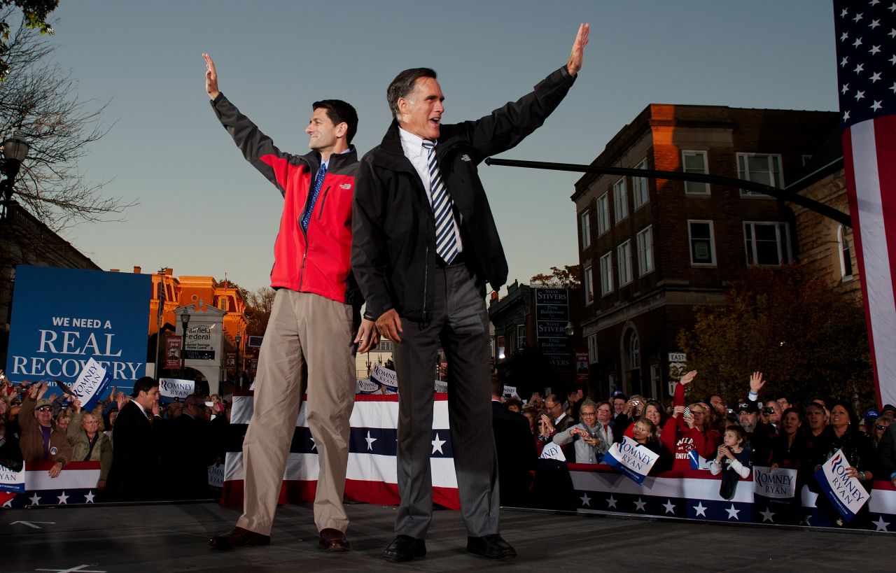 Romney, right, and GOP vice-presidential candidate Paul Ryan greet supporters as they arrive at a rally in Lancaster, Ohio, on Friday.