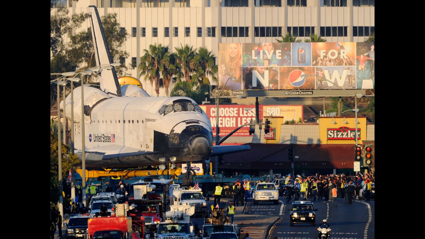 The space shuttle Endeavour is transported to The Forum arena for a stopover and celebration on Saturday.