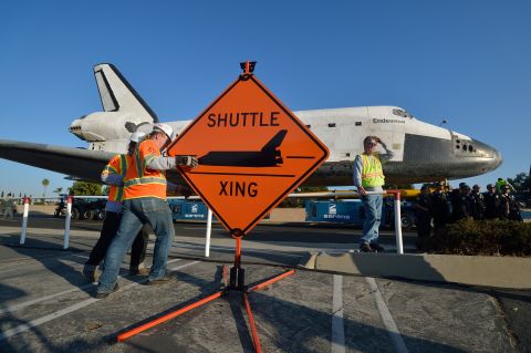 Work crews set up a "Shuttle Xing" sign on Saturday.