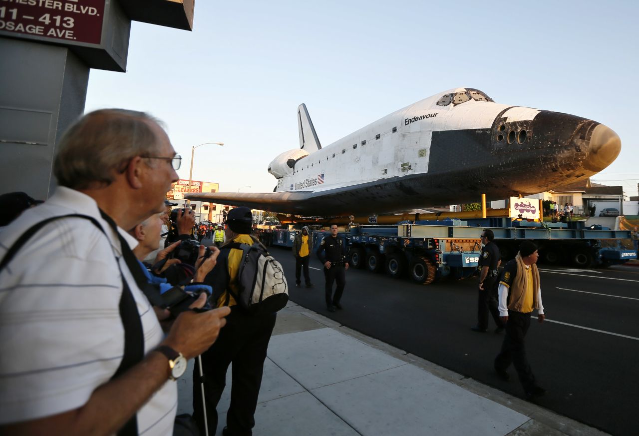 Endeavour is on its last mission: a 12-mile creep through city streets, past an eclectic mix of strip malls, mom-and-pop shops, tidy lawns and faded apartment buildings.