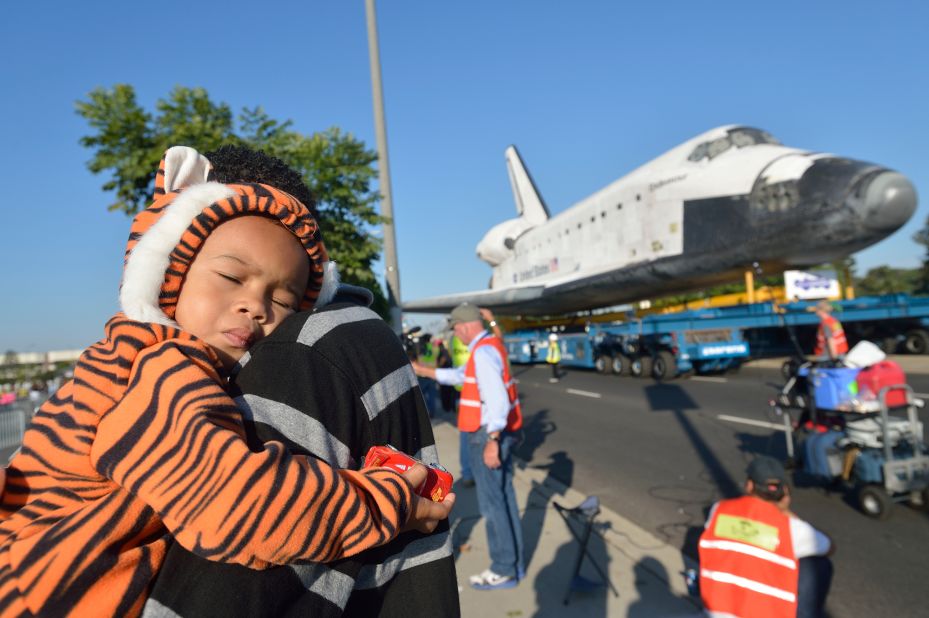 Mikael Ector, 2, tries to get some rest as his dad, Michael Ector, checks out Endeavour as it arrives at the Forum on Saturday.