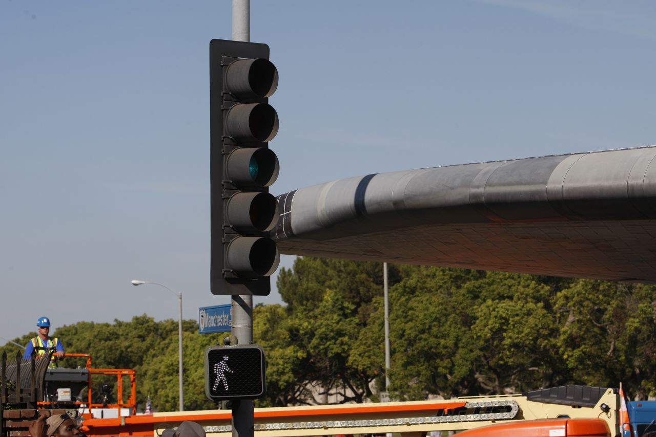 Endeavour passes between traffic lights with just a few inches to spare.