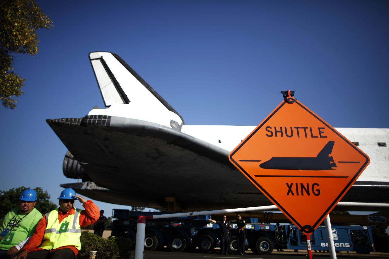 The space shuttle Endeavour passes a "Shuttle crossing" sign on its way to the California Science Center on Saturday in Inglewood, California.