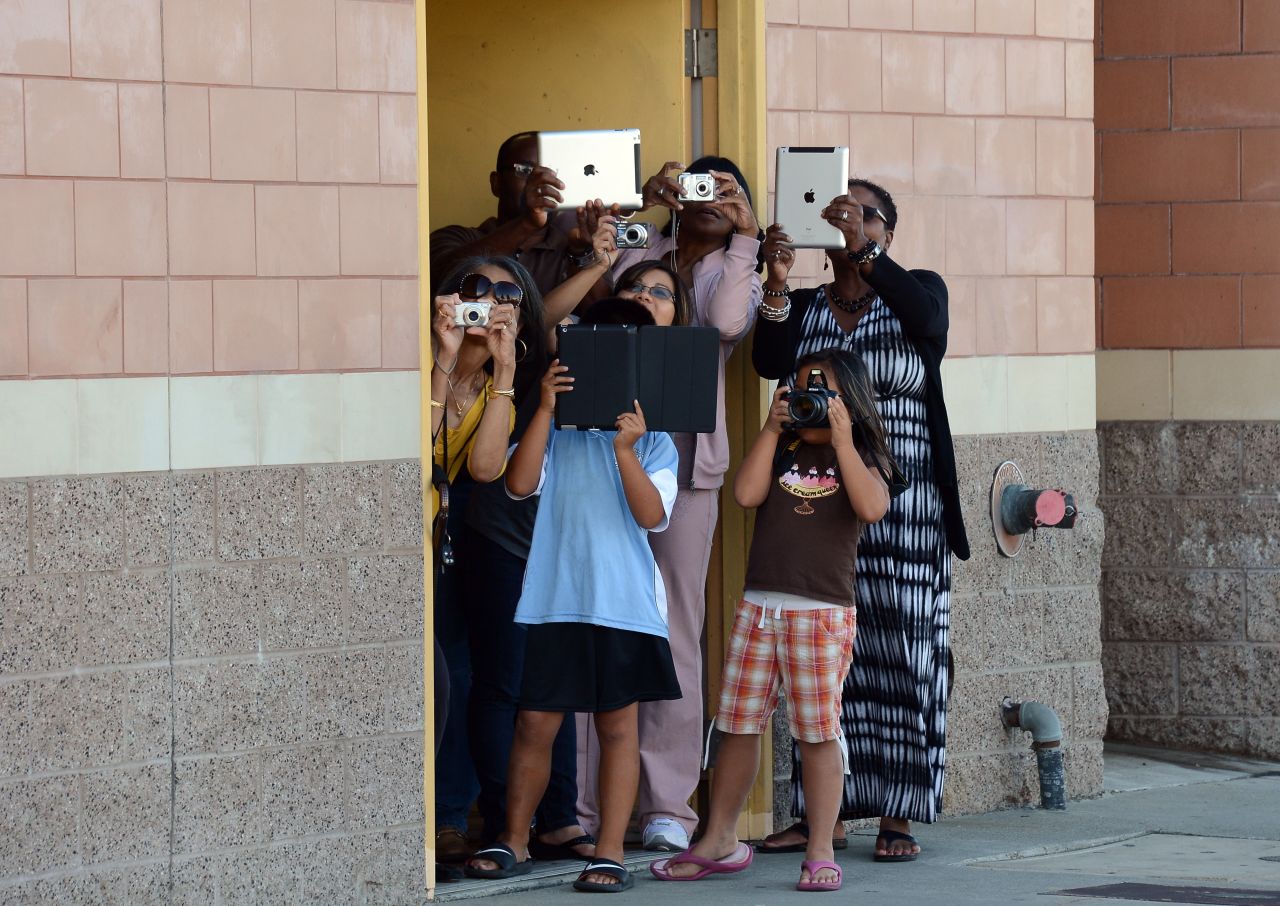 A crowd gathers to take pictures of Endeavour passing through Inglewood on Saturday.