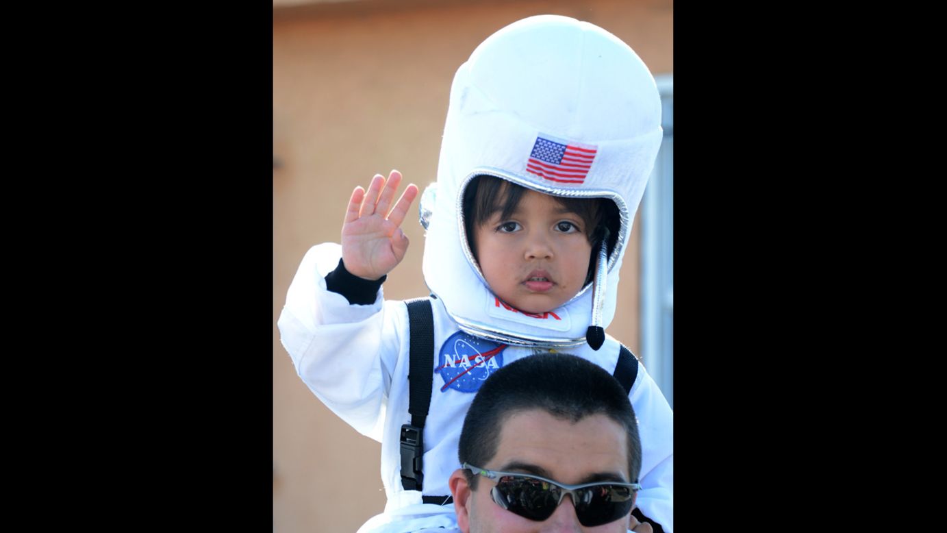A 4-year-old named Levi watches Endeavour make its way down a city street on Saturday.