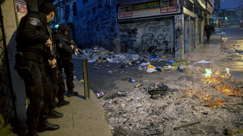 Security personnel take positions during a deployment to pacify shantytowns in Rio de Janeiro on Sunday.