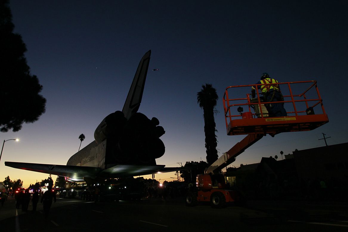 The sun rises as the space shuttle Endeavour slowly moves along Martin Luther King Boulevard to the California Science Center on Sunday.