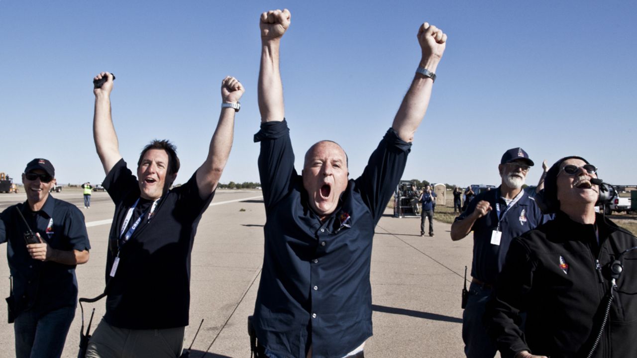 Crew members celebrate Sunday's successful launch. Baumgartner hoped to be the first person to break the sound barrier without the protection of a vehicle.