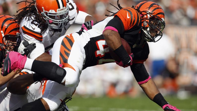 BenJarvus Green-Ellis of the Cincinnati Bengals is hit by Cleveland Browns defenders.