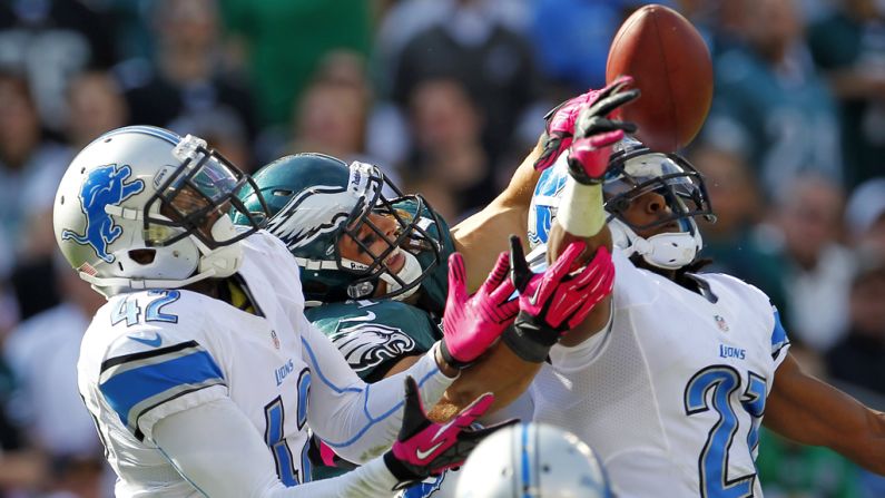 A pass intended for wide receiver Riley Cooper of the Philadelphia Eagles is broken up in the end zone by Amari Spievey, left, and Chris Houston of the Detroit Lions on Sunday.