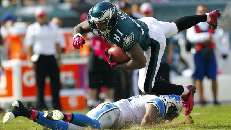 Jason Avant of the Philadelphia Eagles is tackled by Louis Delmas of the Detroit Lions after making a catch in the first half.