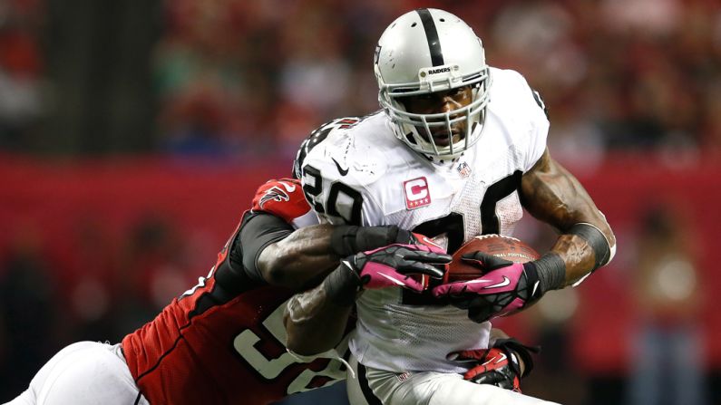 Sean Weatherspoon of Atlanta tackles Oakland's Darren McFadden.