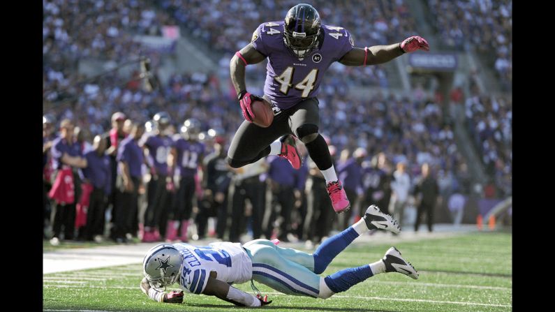 Vonta Leach of the Baltimore Ravens leaps over Morris Claiborne of the Dallas Cowboys before being hit out of bounds in the fourth quarter Sunday.