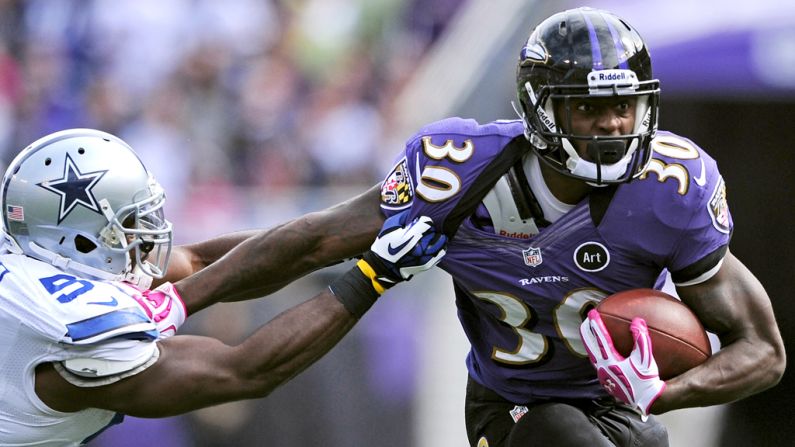 Bernard Pierce of the Ravens tries to break a tackle on Sunday.