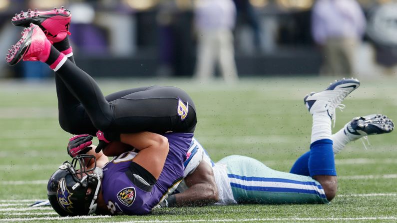 Dennis Pitta of the Baltimore Ravens catches a pass in front of Bruce Carter of the Dallas Cowboys.