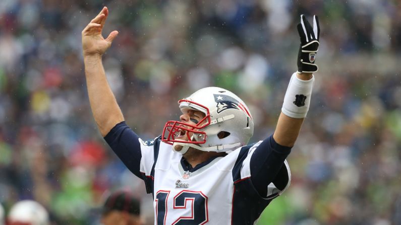 New England's Tom Brady celebrates after throwing a touchdown pass in the first half against Seattle.