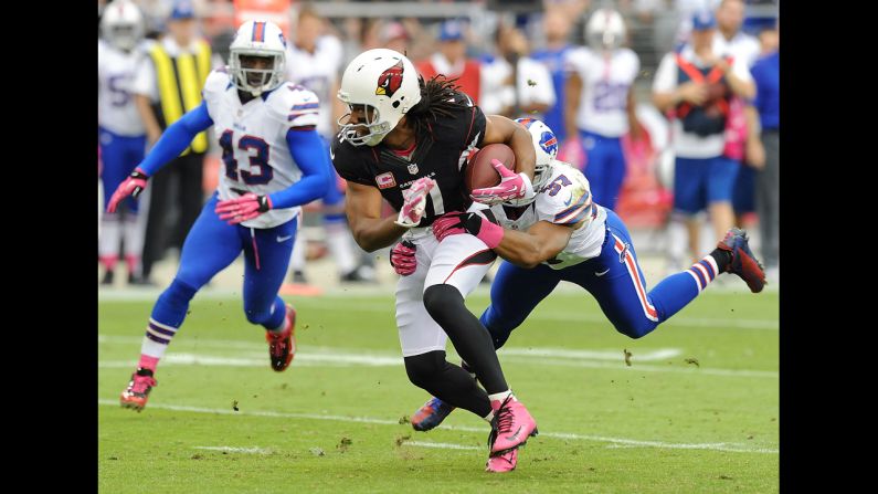 Larry Fitzgerald of the Cardinals breaks a tackle by George Wilson of the Bills.