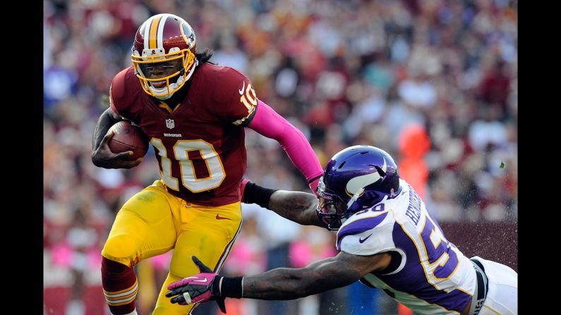 Quarterback Robert Griffin III of the Washington Redskins is tackled by Erin Henderson of the Minnesota Vikings on Sunday at FedExField in Landover, Maryland.