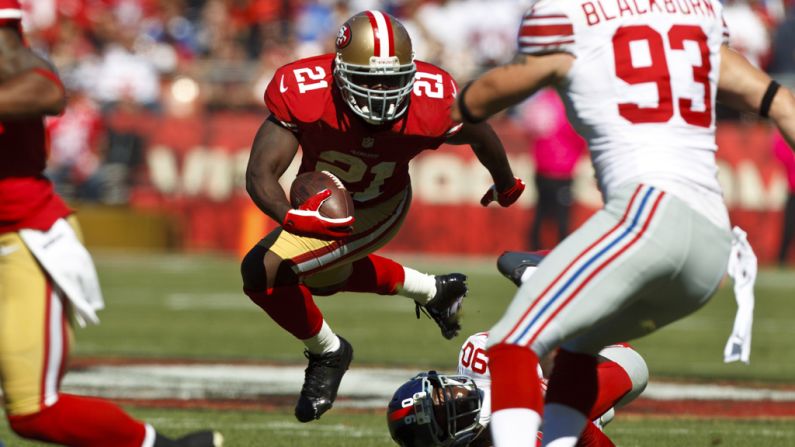 Frank Gore of the San Francisco 49ers breaks a tackle Sunday against the New York Giants at Candlestick Park in San Francisco.