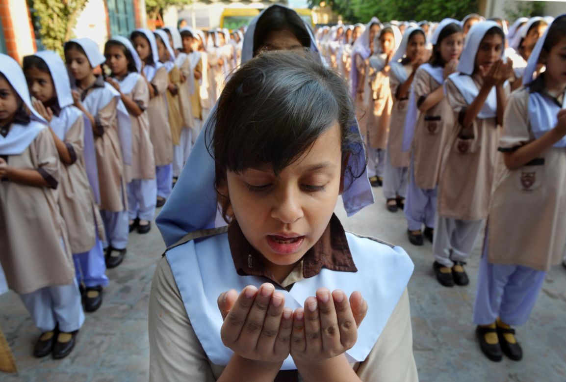 Pakistani school girls pray for the recovery of teen activist Malala Yousufzai at their school in Peshawar.