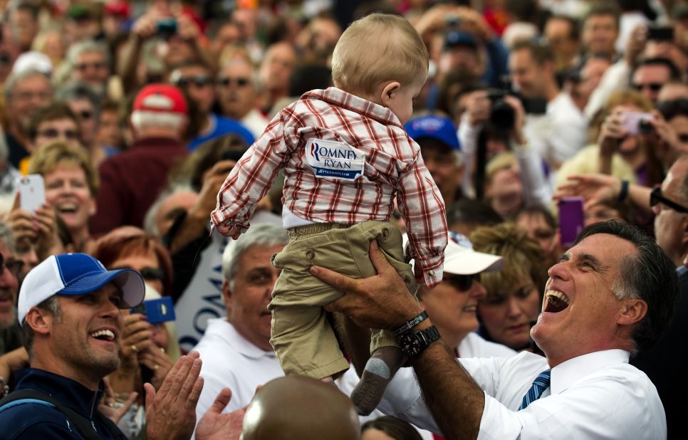 Romney holds up a baby as he works the rope line after delivering remarks at a rally in Lebanon, Ohio, on Saturday, October 13.