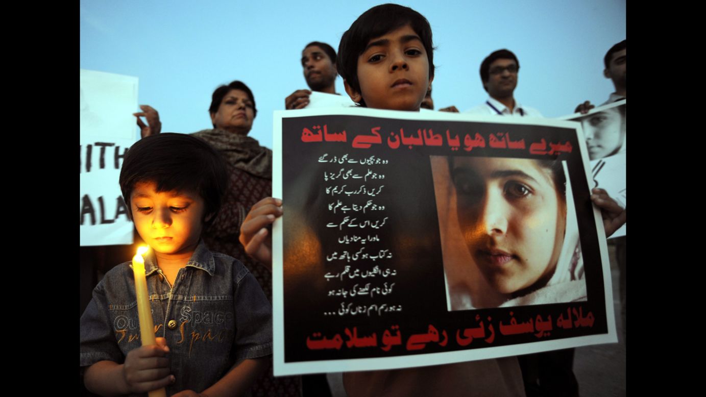 Children of Pakistani journalists and civil society activists light candles in Islamabad.