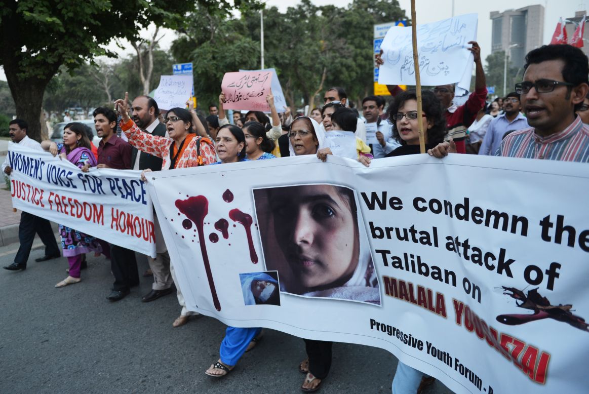 Pakistani civil society activists carry banners in Islamabad on Wednesday as they shout ant-Taliban slogans during a protest against the assassination attempt.