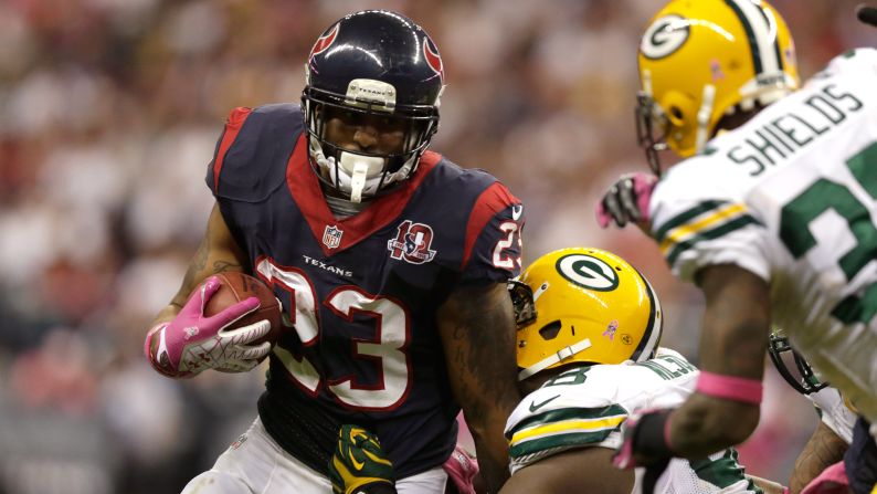 Arian Foster of the Houston Texans is tackled by C.J. Wilson of the Green Bay Packers on Sunday, October, 14, at Reliant Stadium in Houston.