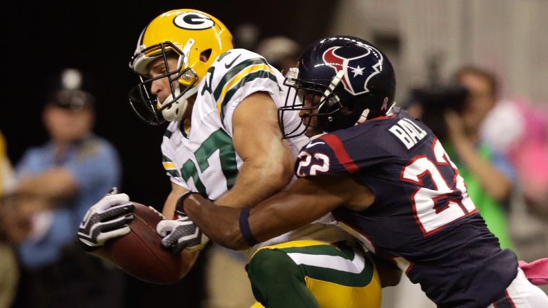 Alan Ball of the Houston Texans defends as Jordy Nelson of the Green Bay Packers catches a pass for a touchdown.