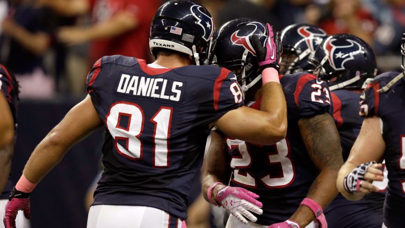 Owen Daniels congratulates Texans teammate Arian Foster after a touchdown in the second quarter against the Packers.