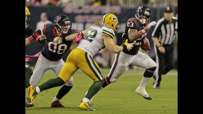 Houston's Arian Foster looks for room to run as he is pursued by Clay Matthews of Green Bay.
