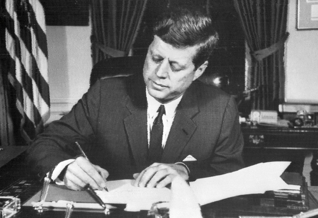 President John F. Kennedy signs the order of naval blockade of Cuba on October 24, 1962.