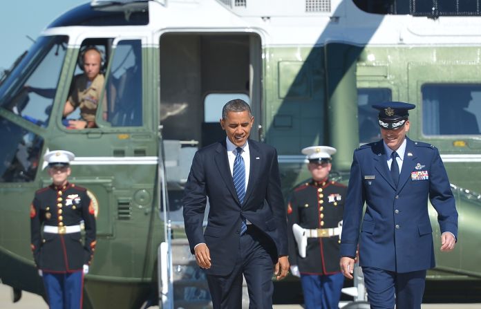 Obama is more often seen on the campaign trial in a suit, as seen here on his way to  a campaign rally in Miami, Florida. For a more casual look, he often loses the jacket and rolls up his sleeves.