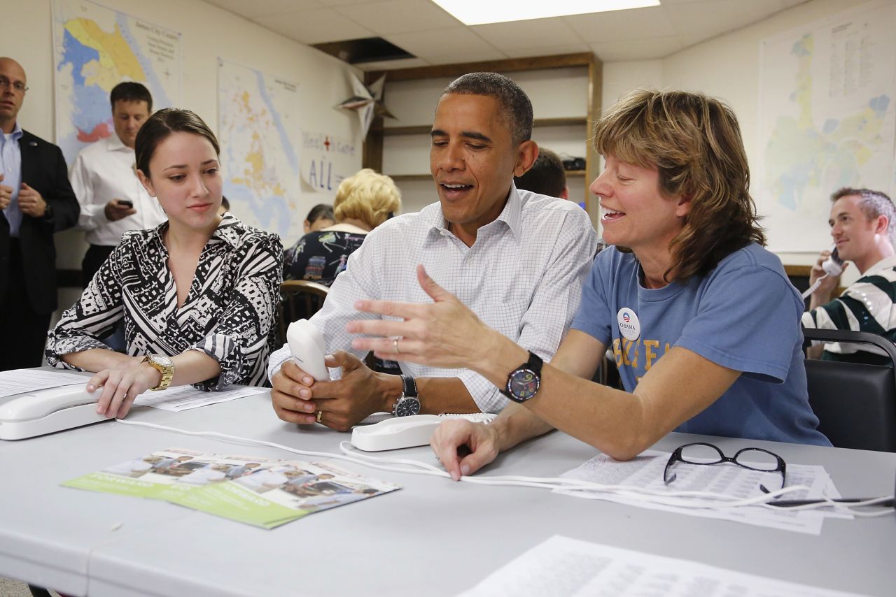 Obama jokes about a telephone with campaign volunteers Alexa Kissinger, left, and Suzanne Stern as he makes calls from a campaign office in Williamsburg, Virginia, on Sunday, October 14.