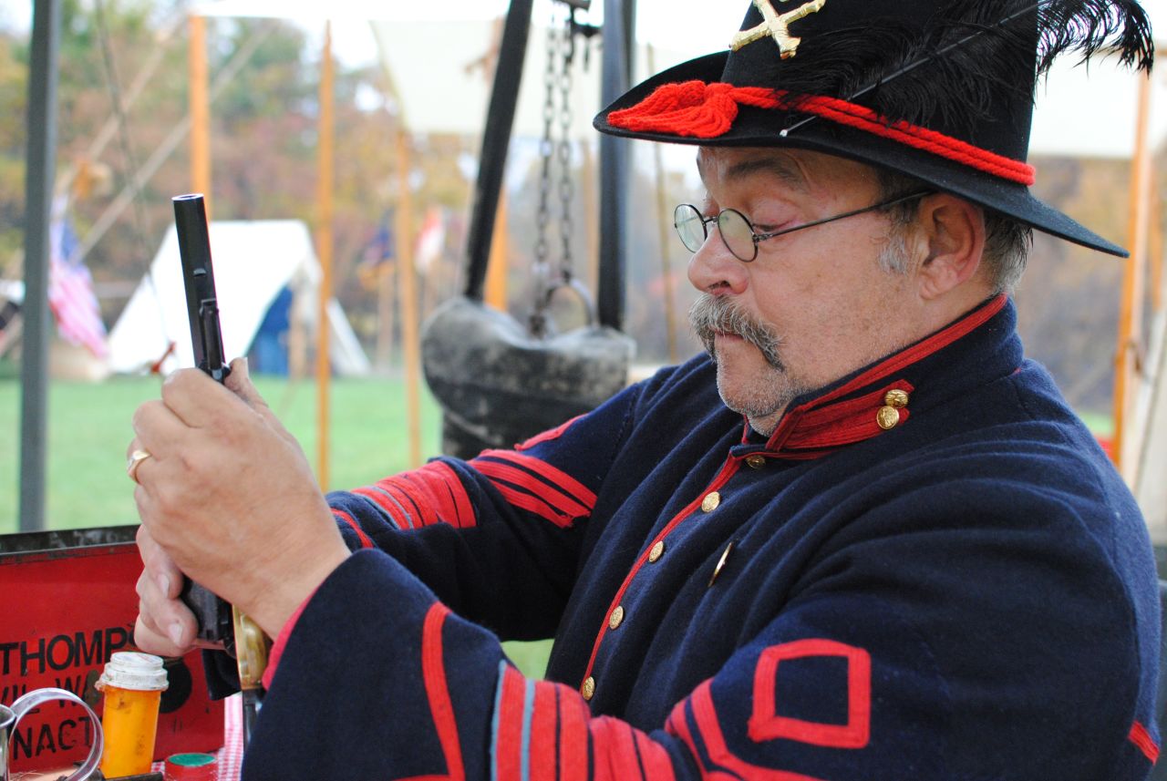 A U.S. civil war enthusiast cleans his pistol and prepares for a re-enactment battle in the swing-state of Iowa
