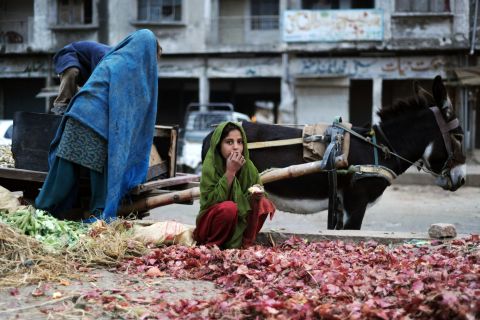 A Pakistani girl collects onions in the garbage of vegetable market in the capital in 2009. While Islamabad's 'civil society' is following the U.S. election, Alam says the race is only of marginal interest to Pakistan's working classes.