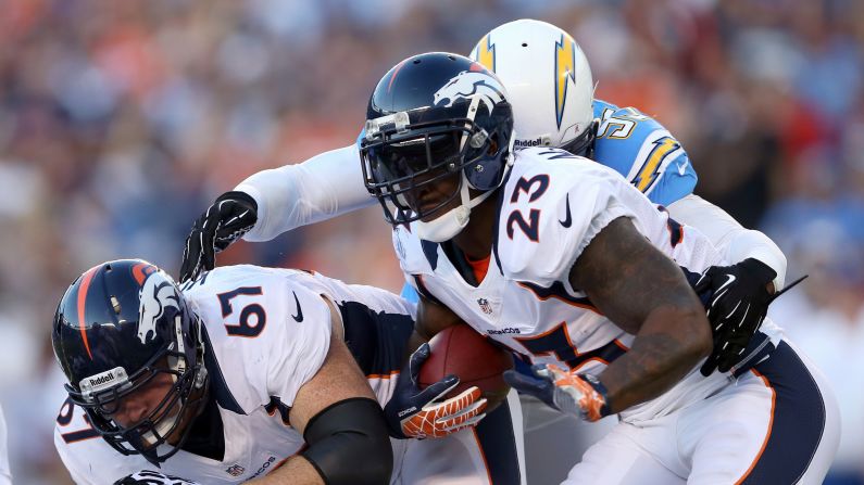 Willis McGahee of the Broncos looks for room to run alongside teammate Dan Koppen, left.