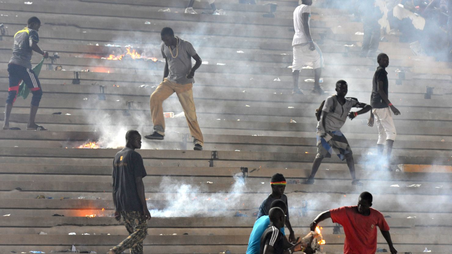 Fans set fire to the stands in Dakar on Saturday, as Ivory Coast's second goal effectively eliminated the hosts from the 2013 Africa Cup of Nations, with the Confederation of African Football disqualifying Senegal from the tournament on Tuesday. 