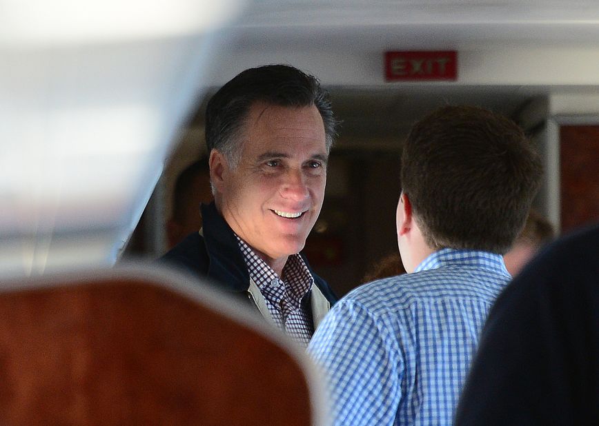 Republican presidential candidate Mitt Romney talks with aides aboard his campaign plane en route to Ronkonkoma, New York, on Tuesday.