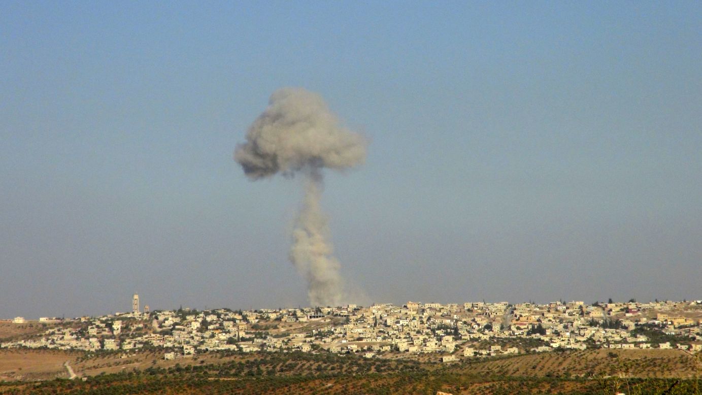 A handout photo from the Shaam News Network shows smoke rising after a Syrian Air Force fighter jet fired missiles at the suburbs of the northern province of Idlib, Syria, on Tuesday, October 16. Click through the gallery to view images of the war-torn country in October. <a href="http://www.cnn.com/2012/10/09/world/gallery/syria-unrest-september/index.html" target="_blank">See photographs from September.</a>