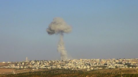 Smoke rises after a Syrian Air Force fighter jet fired missiles at the suburbs of the northern province of Idlib on October 16, 2012.