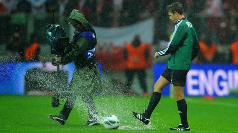 Match referee Gianluca Rocchi inspects the pitch prior to canceling Tuesday's World Cup Qualifier between Poland and England.