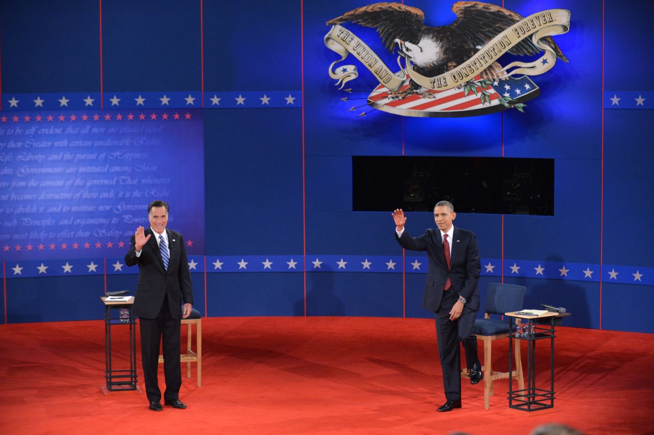U.S. President Barack Obama and Republican presidential nominee Mitt Romney greet the audience.