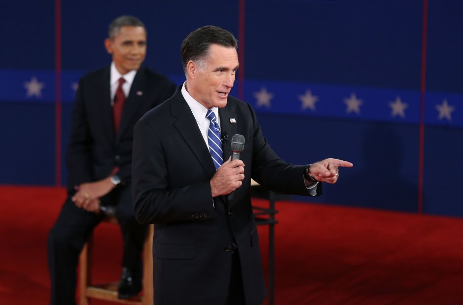 Republican presidential candidate Mitt Romney addresses a question as President Obama listens.
