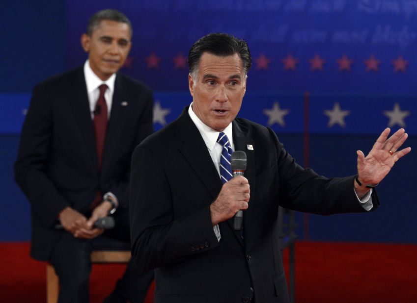 U.S. President Barack Obama listens to Republican presidential candidate Mitt Romney.