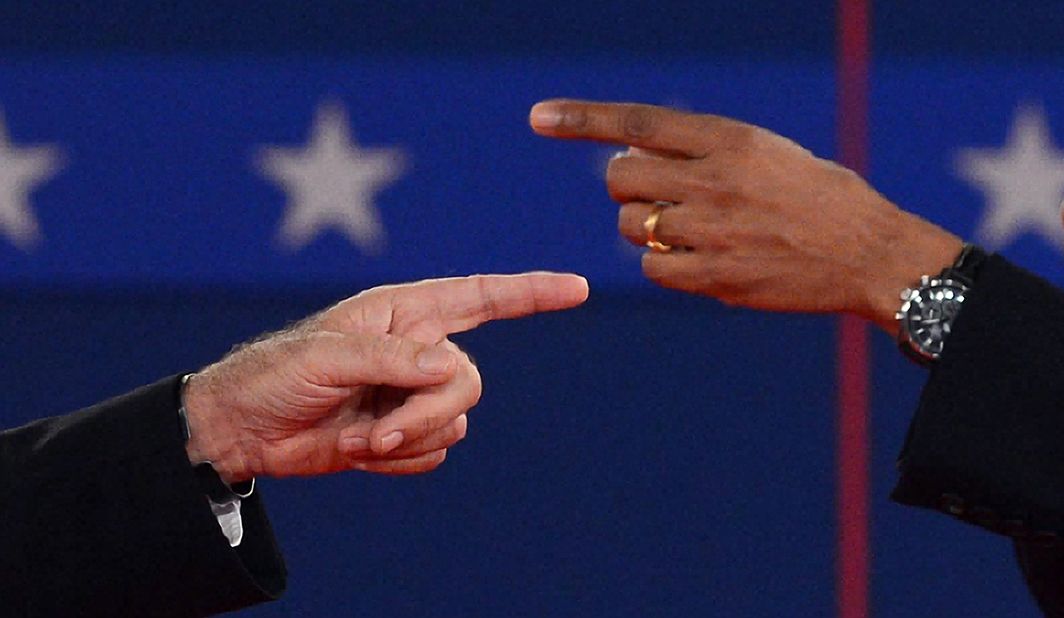 U.S. President Barack Obama and Republican presidential candidate Mitt Romney point fingers at each other.